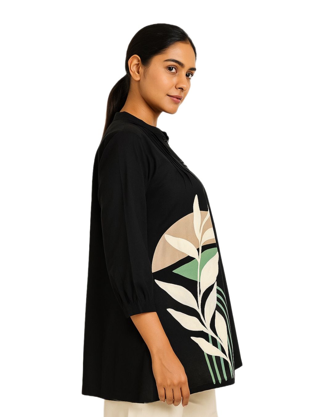 Woman wearing a black sweater with a leaf pattern on a white background